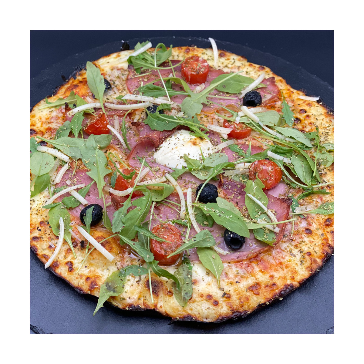 ITALIENNE : Sauce tomate maison, mozzarella 100 %, jambon cru, olives, tomates cerises, roquette, Comté AOC, origan.