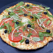MARGHERITA DU CHEF : Sauce tomate maison, mozzarella 100 %, rondelles de tomate, olives, roquette, Comté AOC, origan.