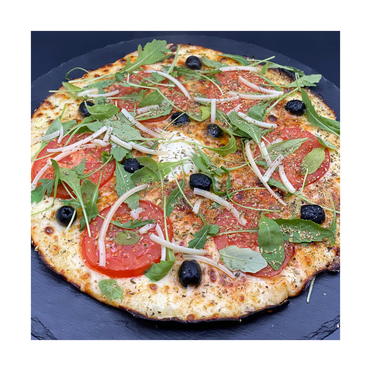 MARGHERITA DU CHEF : Sauce tomate maison, mozzarella 100 %, rondelles de tomate, olives, roquette, Comté AOC, origan.