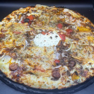 BUFFALO : Crème fraîche, mozzarella 100 %, steak haché, merguez, poivrons grillés, oignons, comté, barbecue (halal).