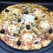 BERGERE : Sauce tomate maison, mozzarella 100 %, artichauts à la romaine, champignons, chèvre, olives, origan.